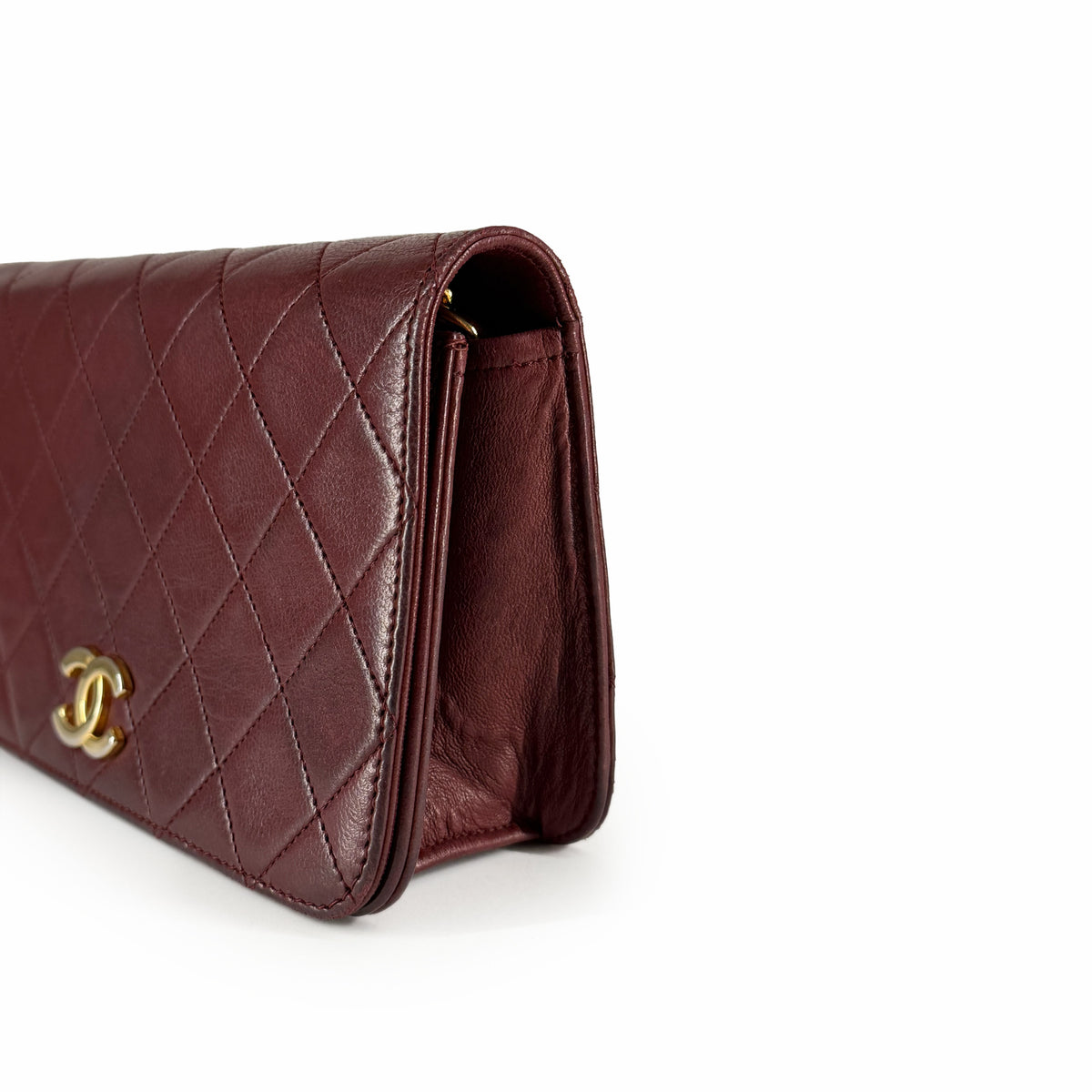 Burgundy quilted leather Chanel wallet with gold-tone logo, curated Pre-loved Luxury by Myluxe in Helsinki.