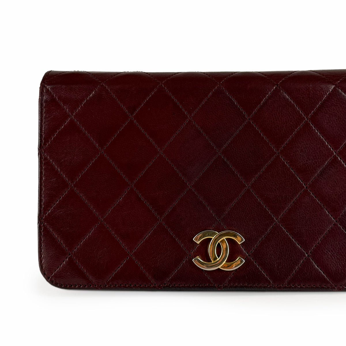 Burgundy quilted leather Chanel wallet with gold-tone CC logo, curated Pre-loved Luxury by Myluxe in Helsinki.