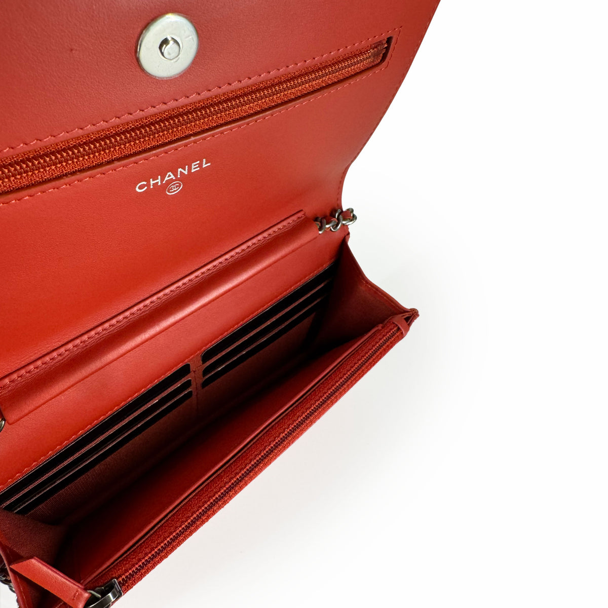 Interior of a red leather Chanel handbag with multiple card slots, curated Pre-loved Luxury by Myluxe in Helsinki.