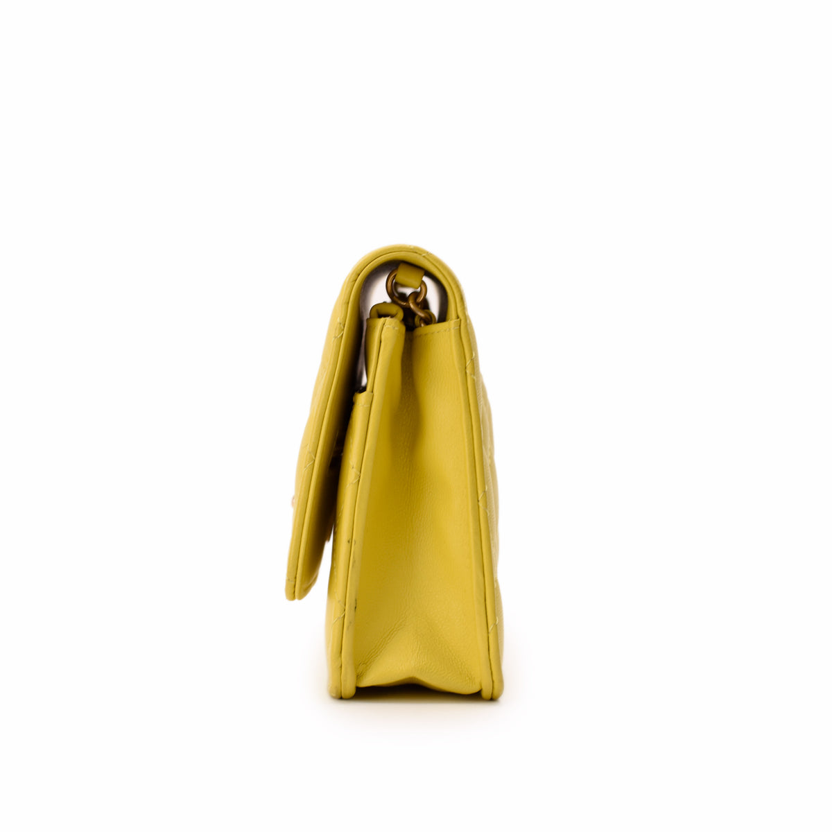 Side view of a yellow quilted leather handbag with gold-tone hardware, curated Pre-loved Luxury by Myluxe in Helsinki.