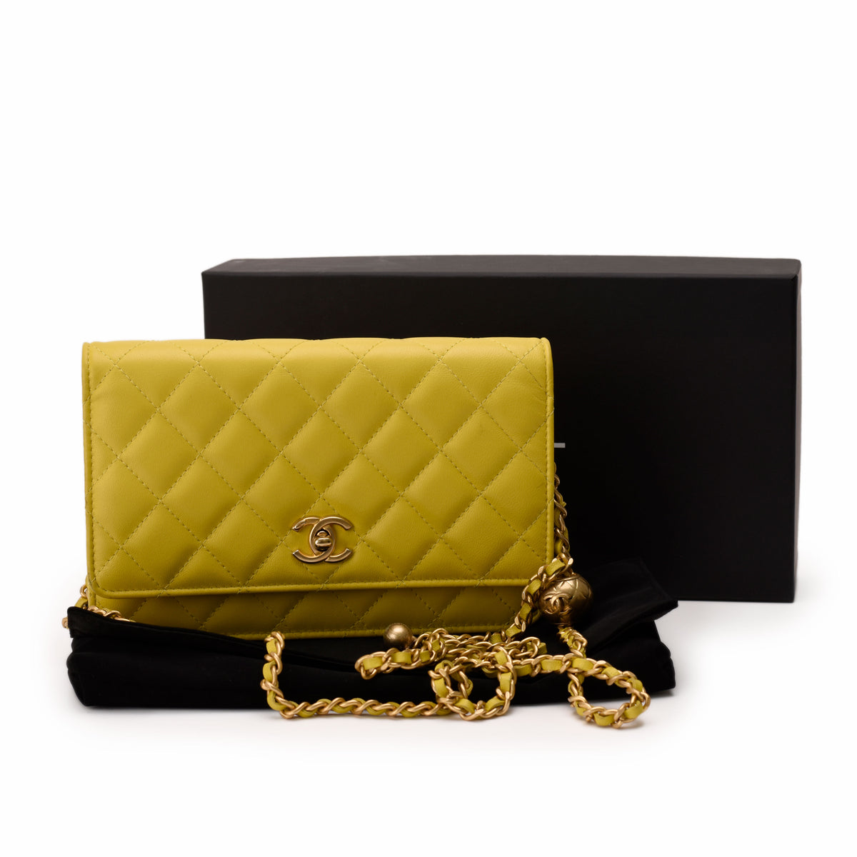 Yellow quilted leather Chanel flap bag with gold chain strap, curated Pre-loved Luxury by Myluxe in Helsinki.