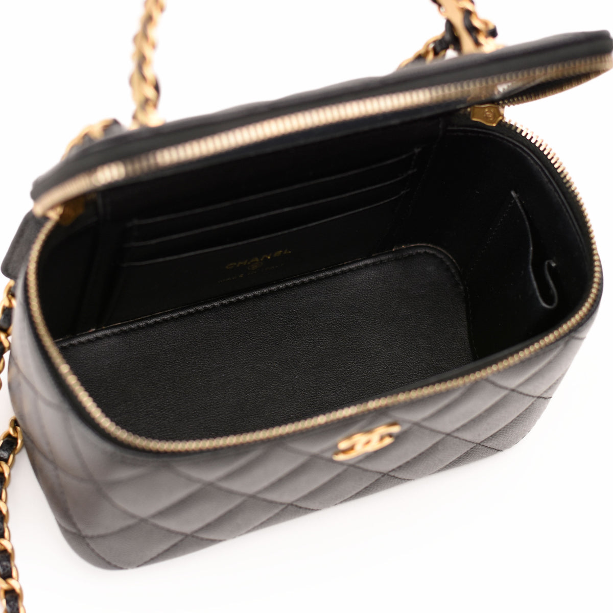 Interior of a black quilted leather Chanel handbag with gold-tone hardware, curated Pre-loved Luxury by Myluxe in Helsinki.