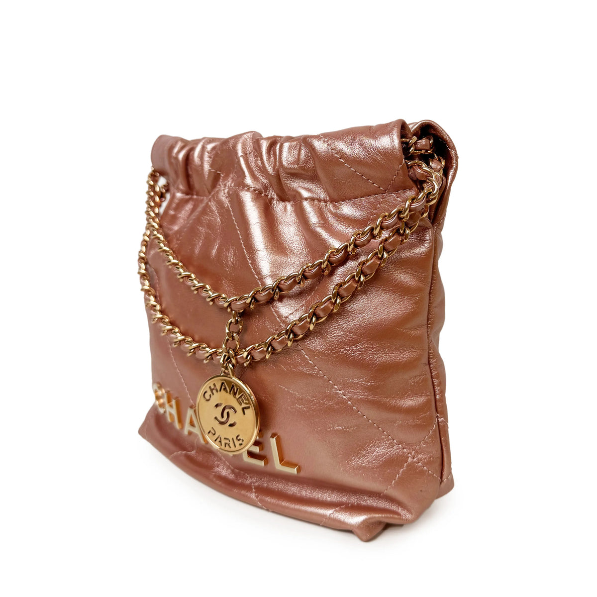 Metallic rose gold Chanel bucket bag with gold chain strap, curated Pre-loved Luxury by Myluxe in Helsinki.