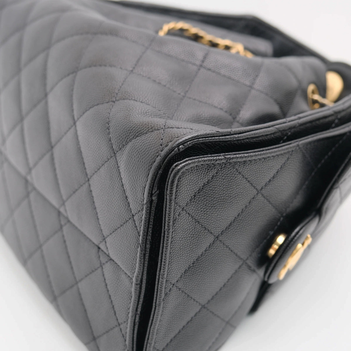 Black quilted caviar leather Chanel handbag with gold-tone chain strap. curated Pre-loved Luxury by Myluxe in Helsinki.