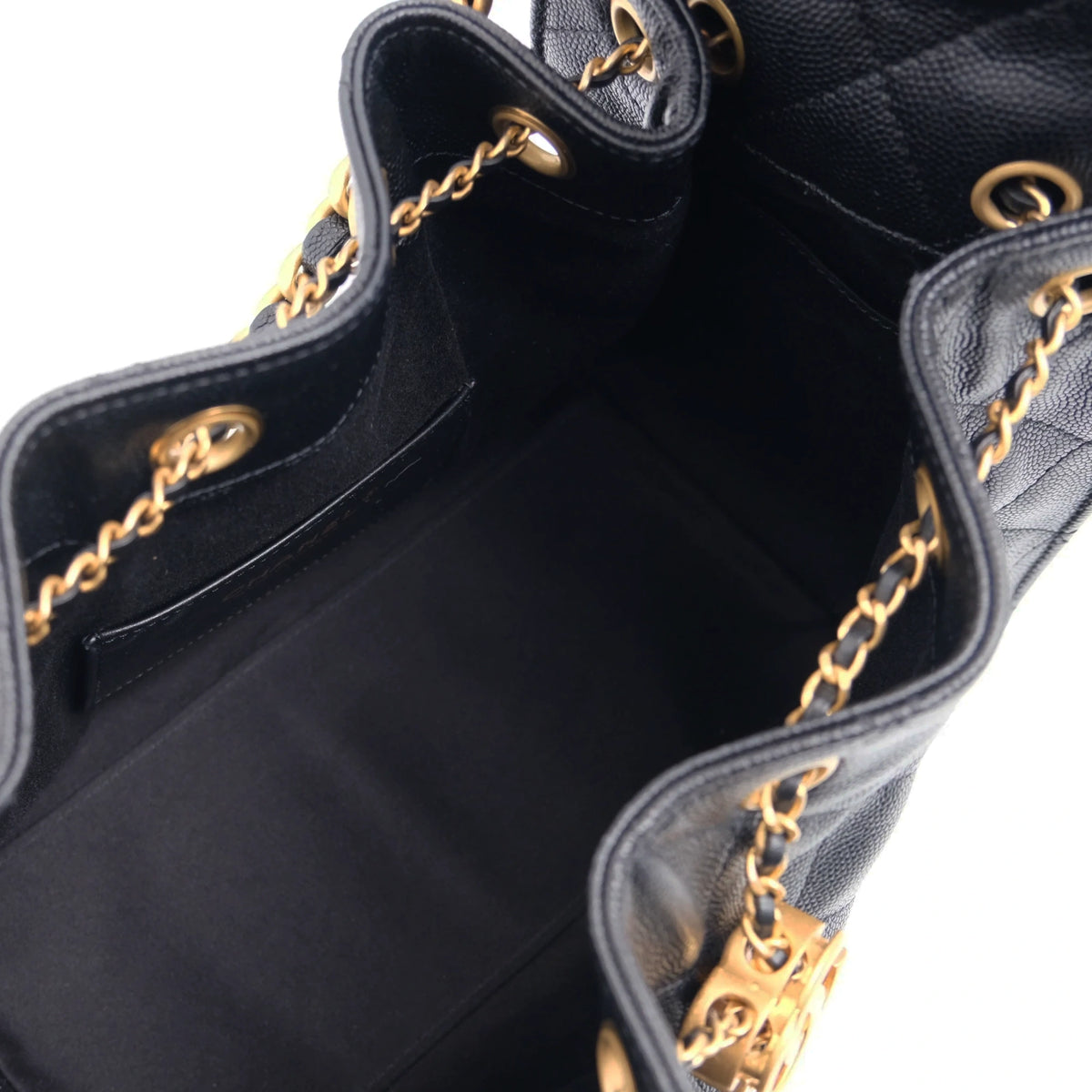 Interior view of a black quilted leather Chanel handbag with gold-tone chain detailing. Curated Pre-loved Luxury by Myluxe in Helsinki.