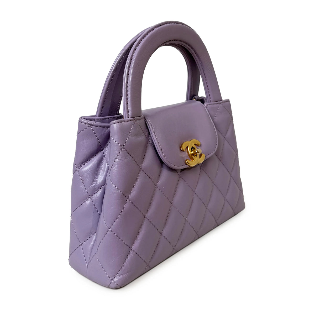 Lavender quilted leather Chanel handbag with gold CC clasp, curated Pre-loved Luxury by Myluxe in Helsinki.