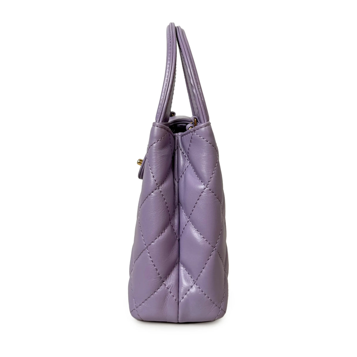 Side view of a lavender quilted leather handbag with top handles, curated Pre-loved Luxury by Myluxe in Helsinki.
