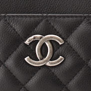 Close-up of Chanel black caviar quilted leather with silver CC logo. curated Pre-loved Luxury by Myluxe in Helsinki.