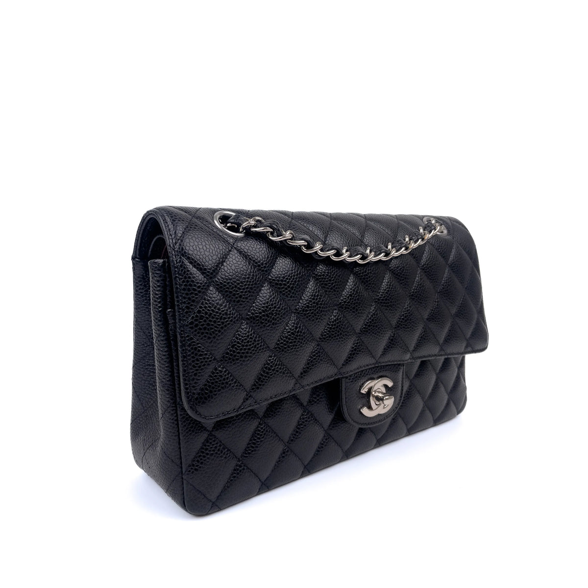 Black quilted caviar leather Chanel flap bag with silver chain strap, curated Pre-loved Luxury by Myluxe in Helsinki.