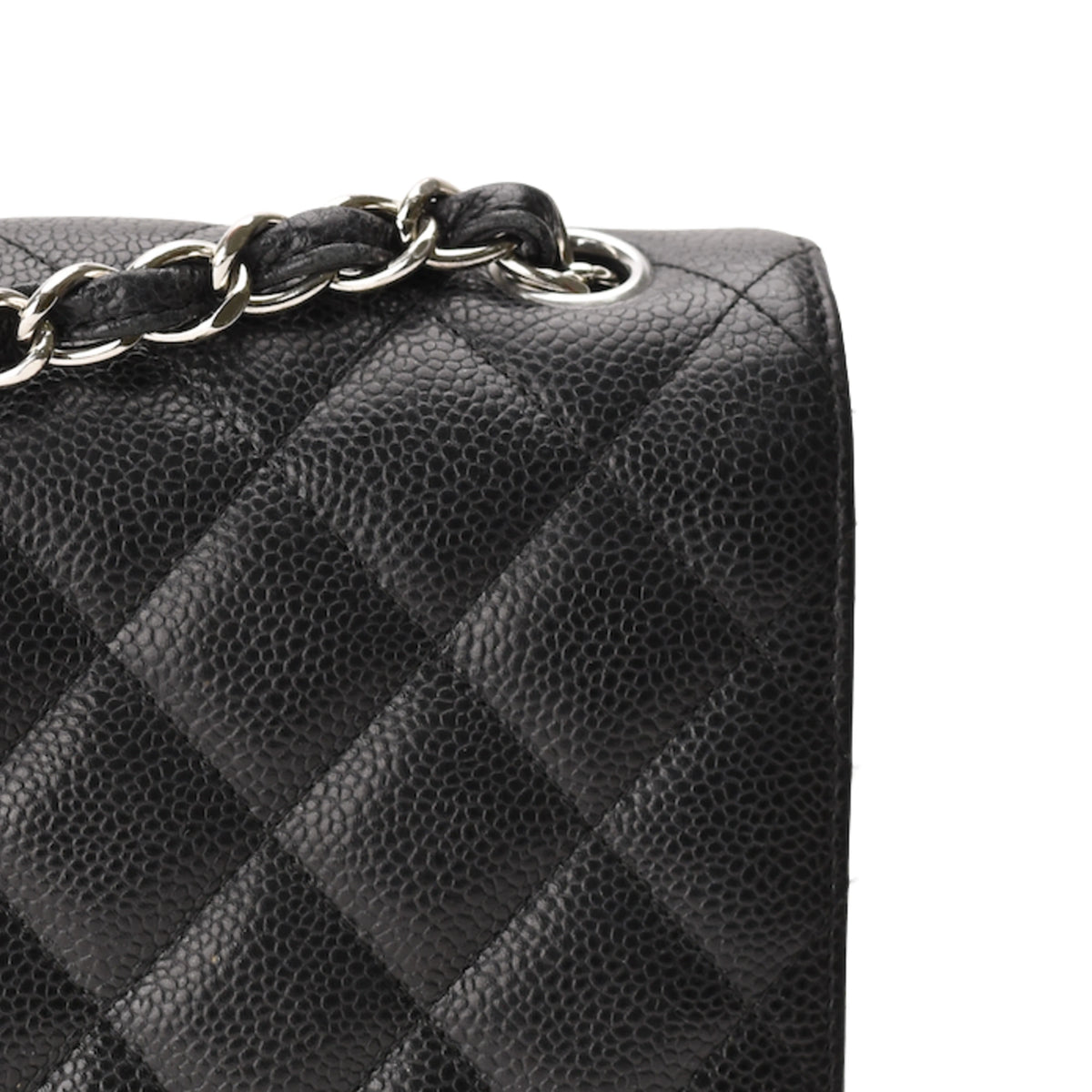 Chanel Timeless Jumbo black caviar leather quilted handbag with silver chain strap. curated Pre-loved Luxury by Myluxe in Helsinki.