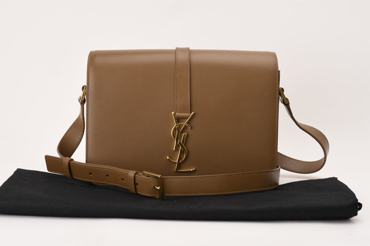 Brown leather Saint Laurent crossbody bag with gold YSL logo. curated Pre-loved Luxury by Myluxe in Helsinki.