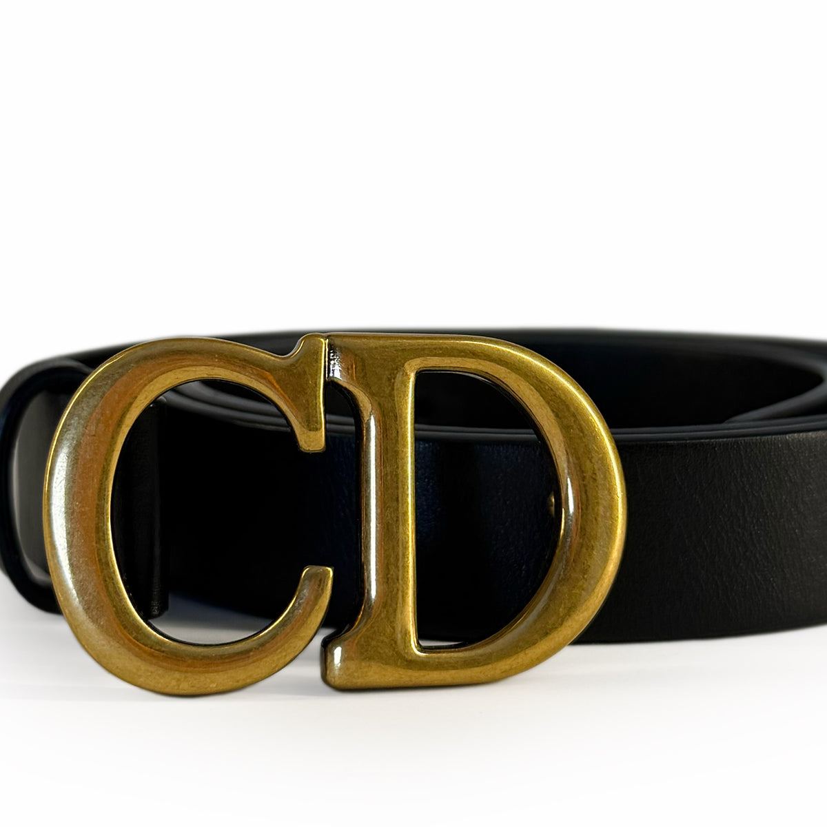 Black leather belt with large gold-tone CD buckle, curated Pre-loved Luxury by Myluxe in Helsinki.