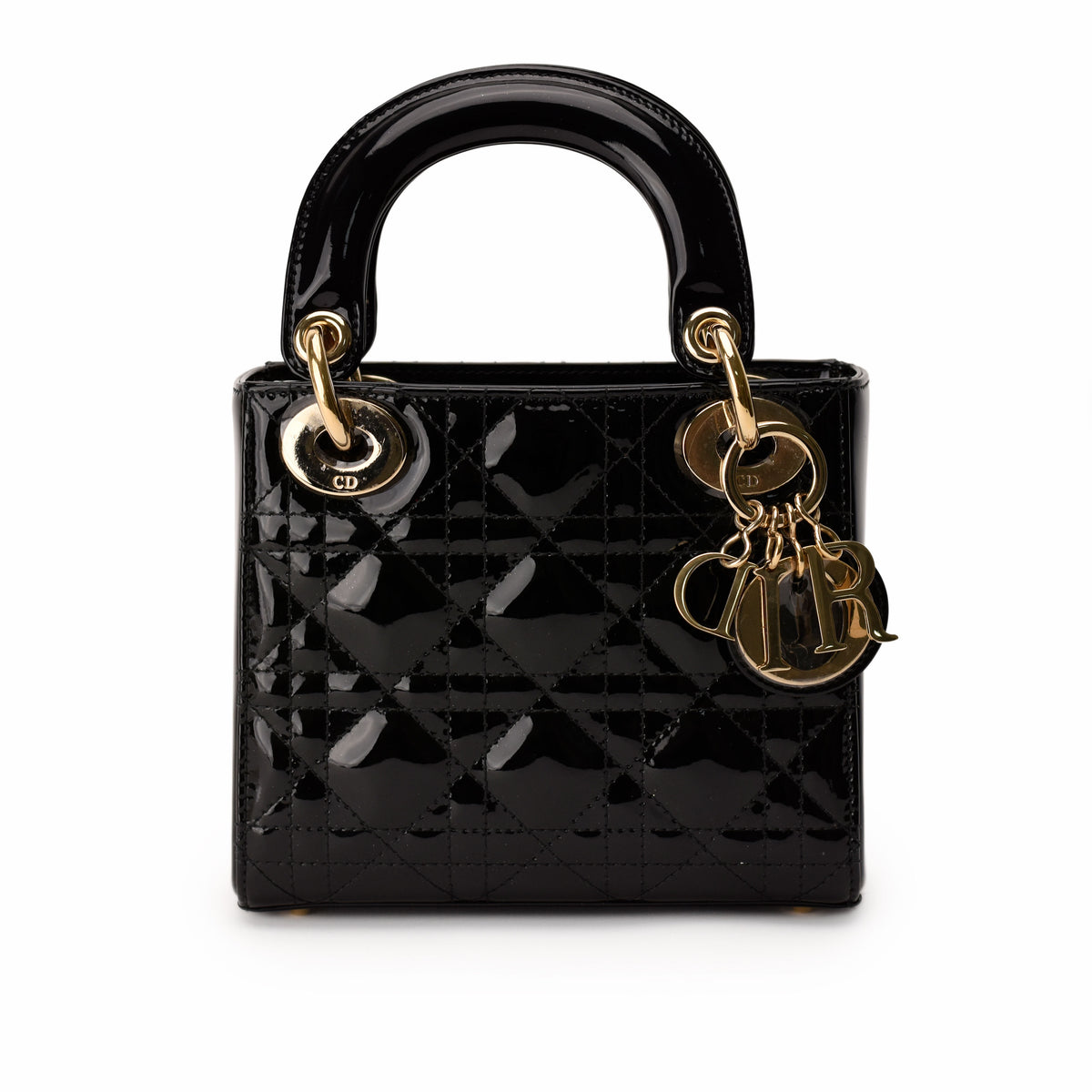 Black patent leather Dior Lady Dior bag with gold charms, curated Pre-loved Luxury by Myluxe in Helsinki.
