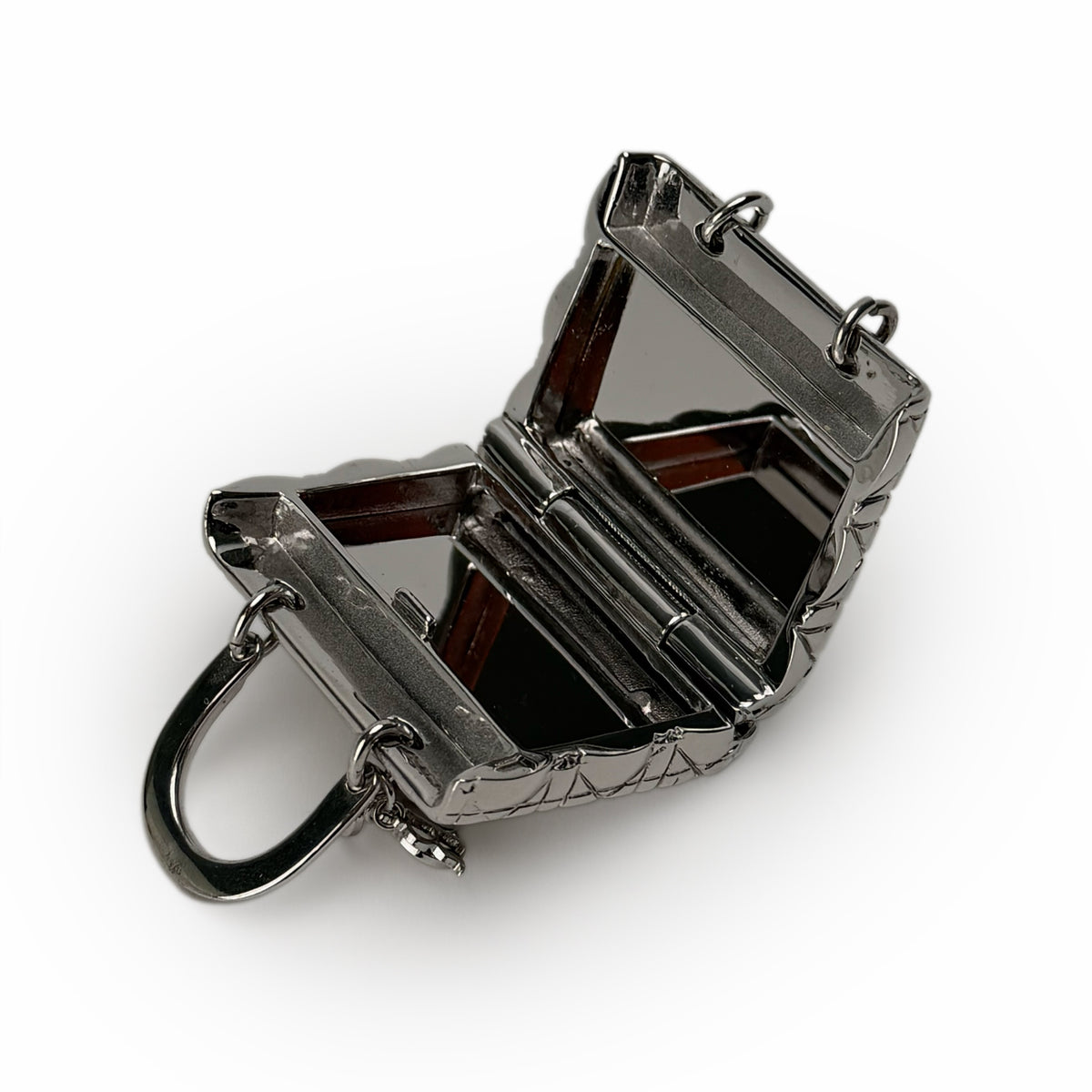 Open silver metallic hard-shell mini handbag with structured design, curated Pre-loved Luxury by Myluxe in Helsinki.