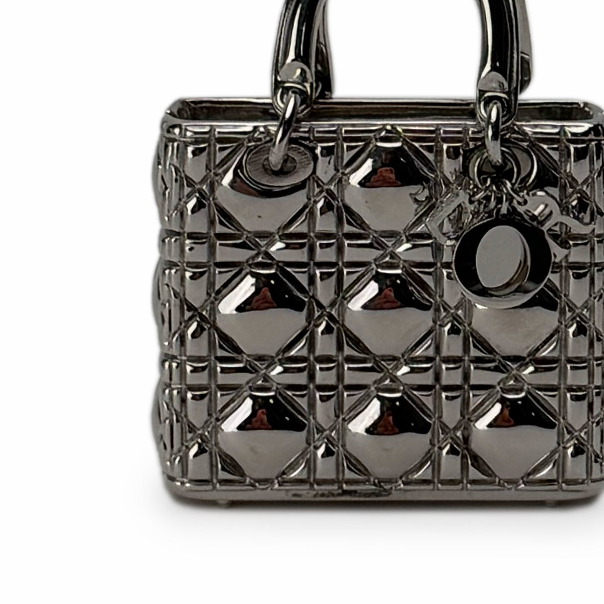 Metallic silver quilted Lady Dior handbag with charm, curated Pre-loved Luxury by Myluxe in Helsinki.