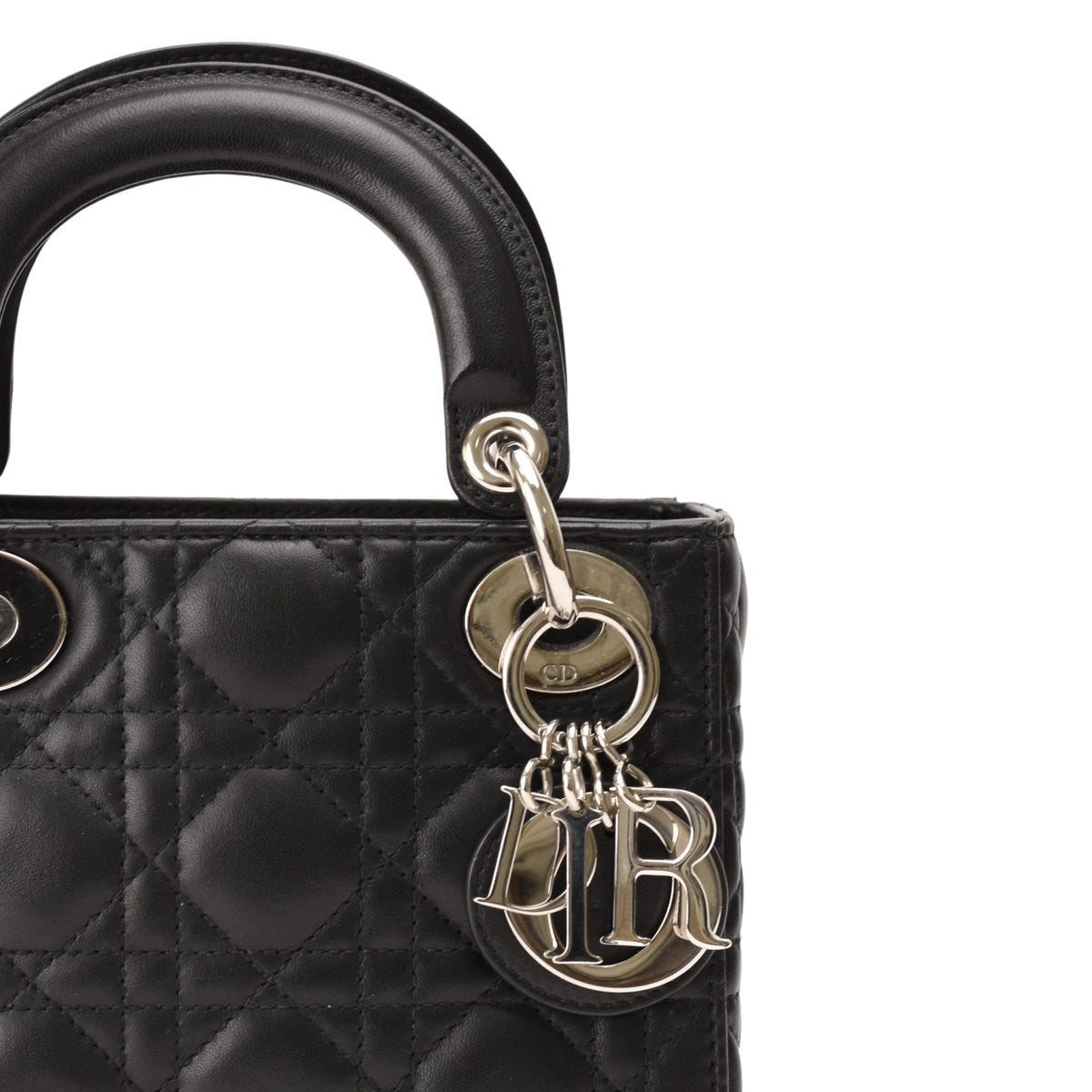 Close-up of black quilted leather Dior handbag with silver CD charm, curated Pre-loved Luxury by Myluxe in Helsinki.