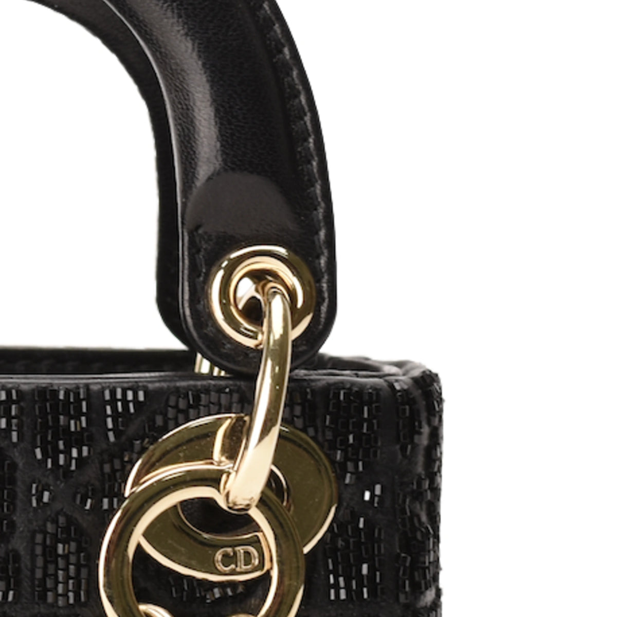 Close-up of Dior black metallic cannage lambskin bag handle with gold hardware. curated Pre-loved Luxury by Myluxe in Helsinki.