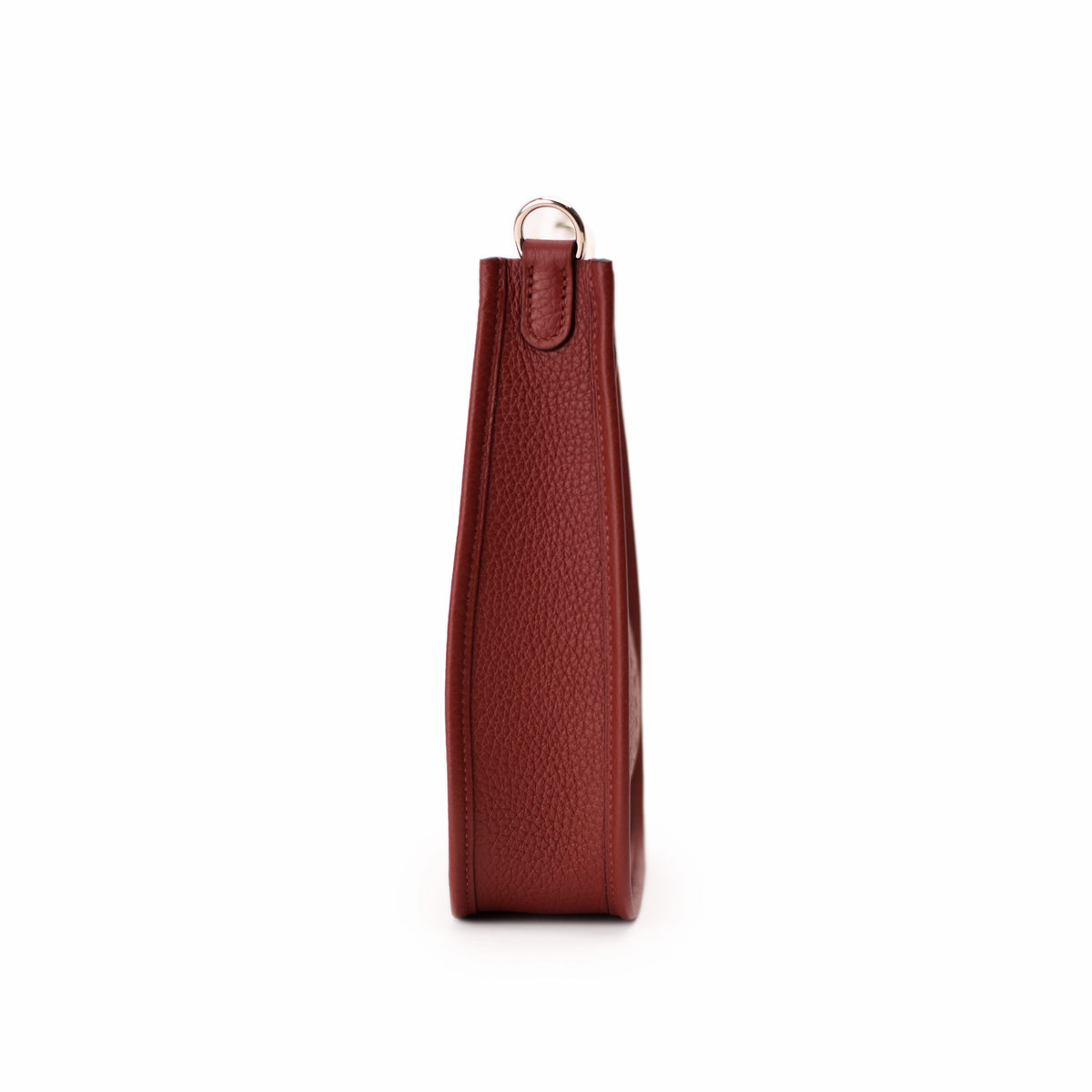 Side view of a textured red leather luxury handbag with gold-tone hardware. curated Pre-loved Luxury by Myluxe in Helsinki.
