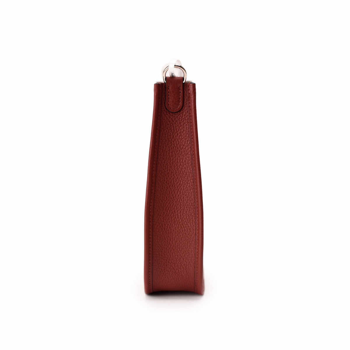 Side view of a burgundy grained leather designer handbag. curated Pre-loved Luxury by Myluxe in Helsinki.