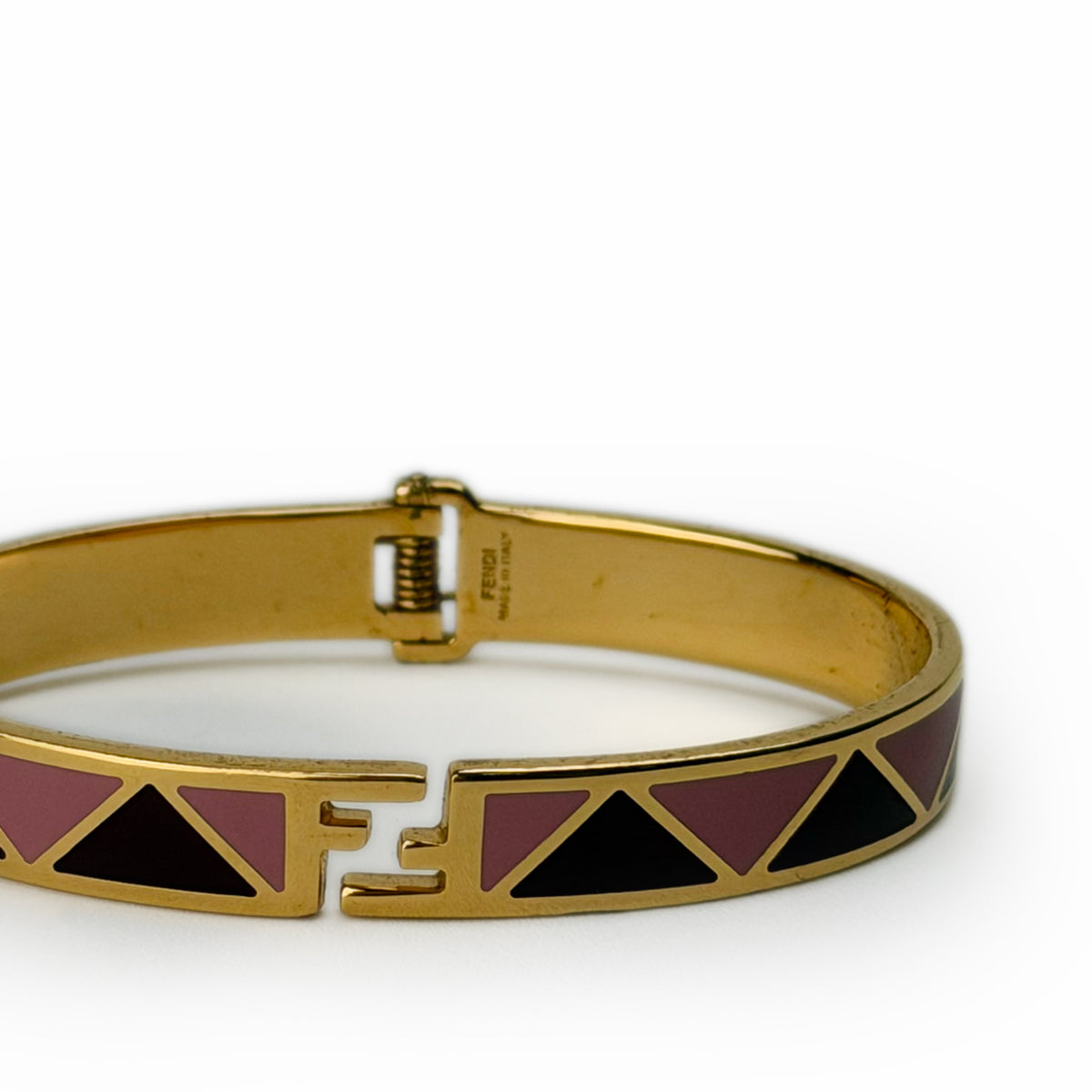 Gold-tone Fendi bangle with pink and black geometric inlay, curated Pre-loved Luxury by Myluxe in Helsinki.