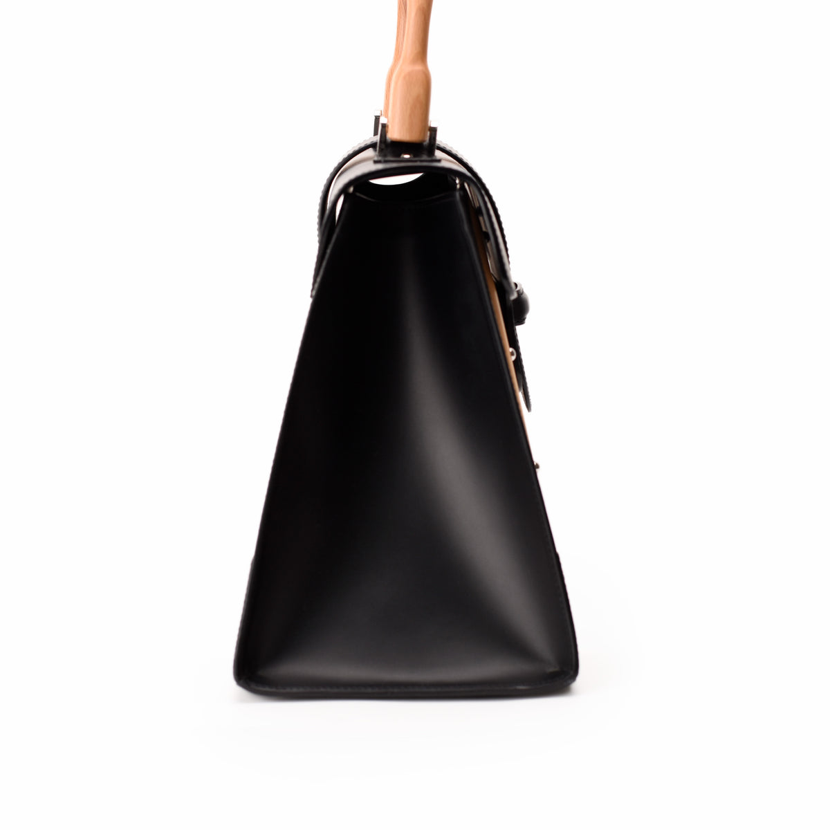 Side view of a black leather luxury handbag with a structured silhouette, curated Pre-loved Luxury by Myluxe in Helsinki.