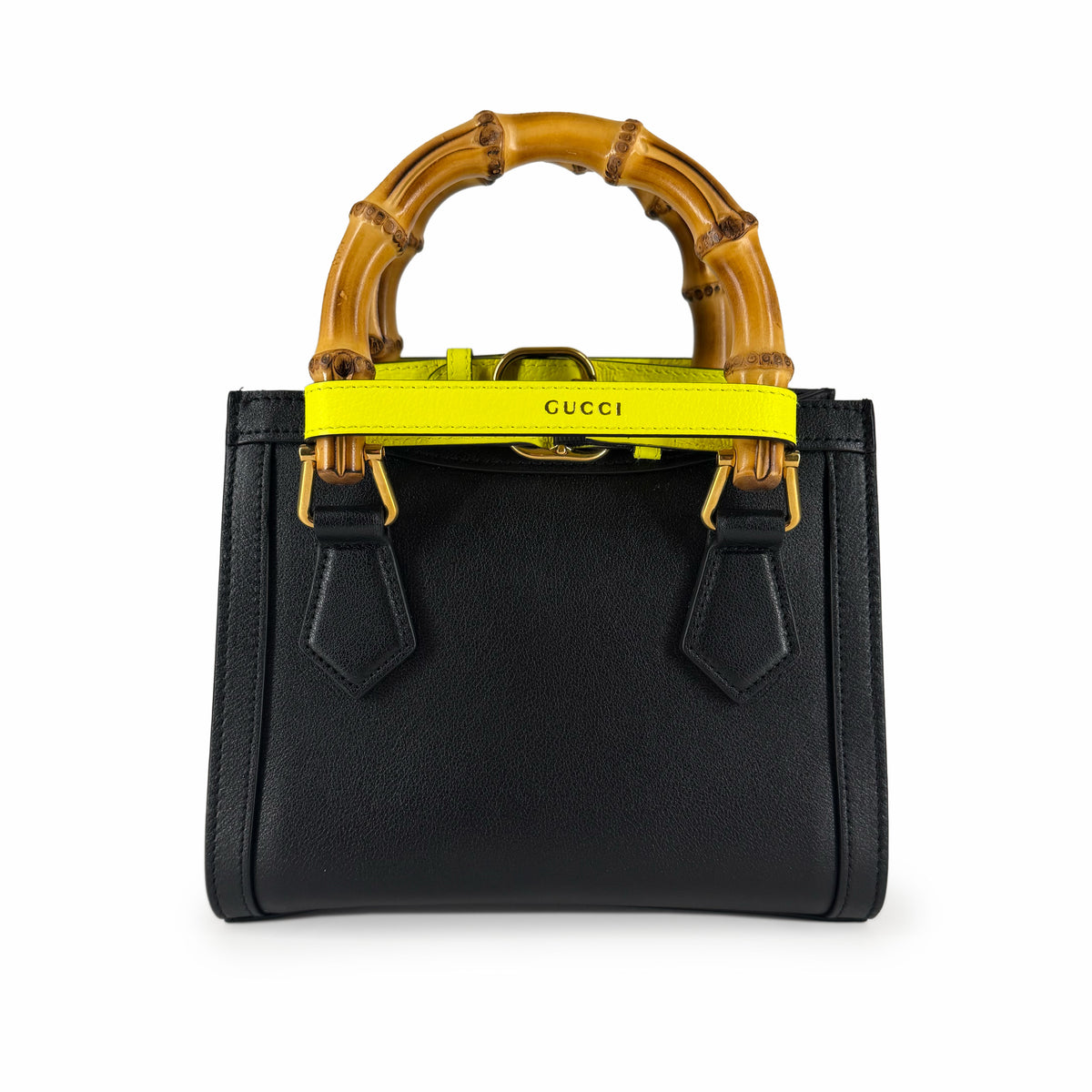 Black Gucci handbag with bamboo handle and yellow strap, curated Pre-loved Luxury by Myluxe in Helsinki.