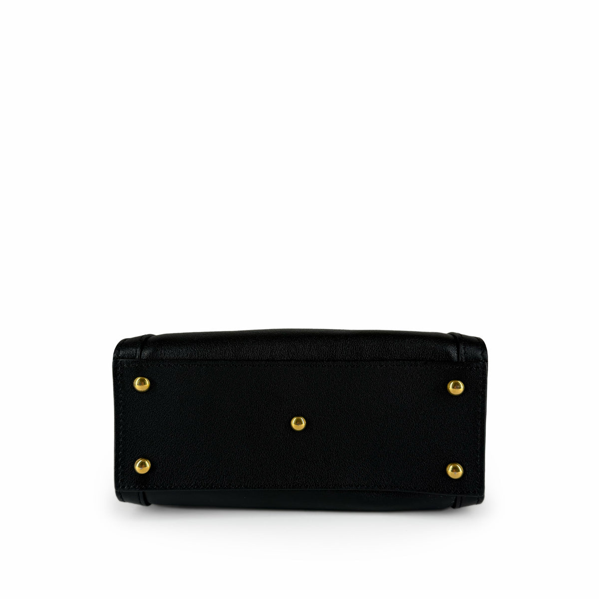 Bottom view of a black textured leather handbag with gold-toned feet, curated Pre-loved Luxury by Myluxe in Helsinki.