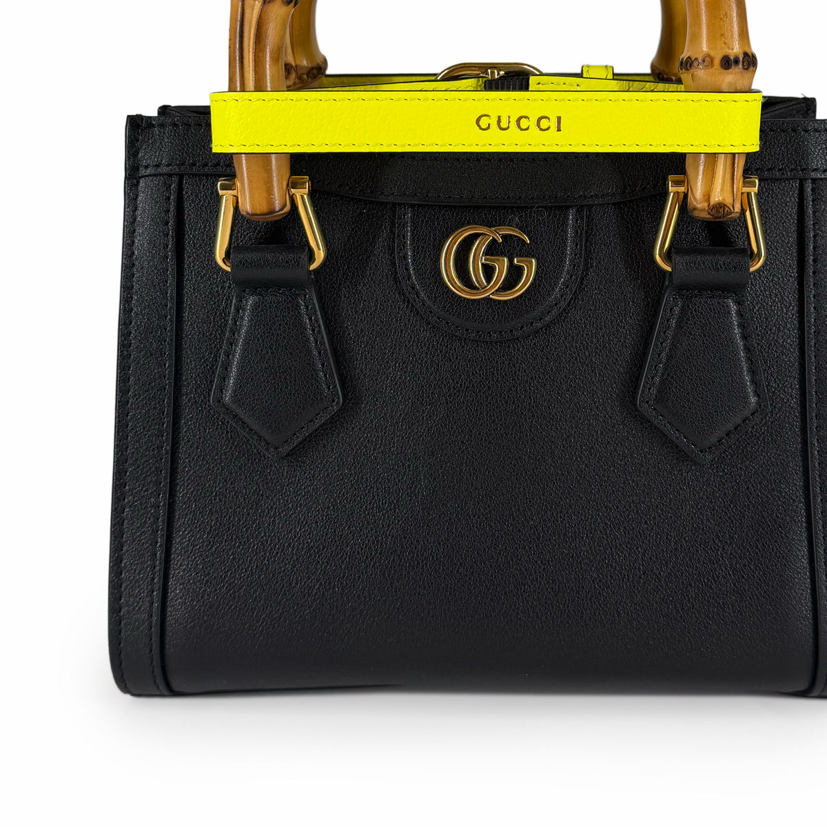 Black grained leather Gucci handbag with bamboo handles and gold GG logo, curated Pre-loved Luxury by Myluxe in Helsinki.