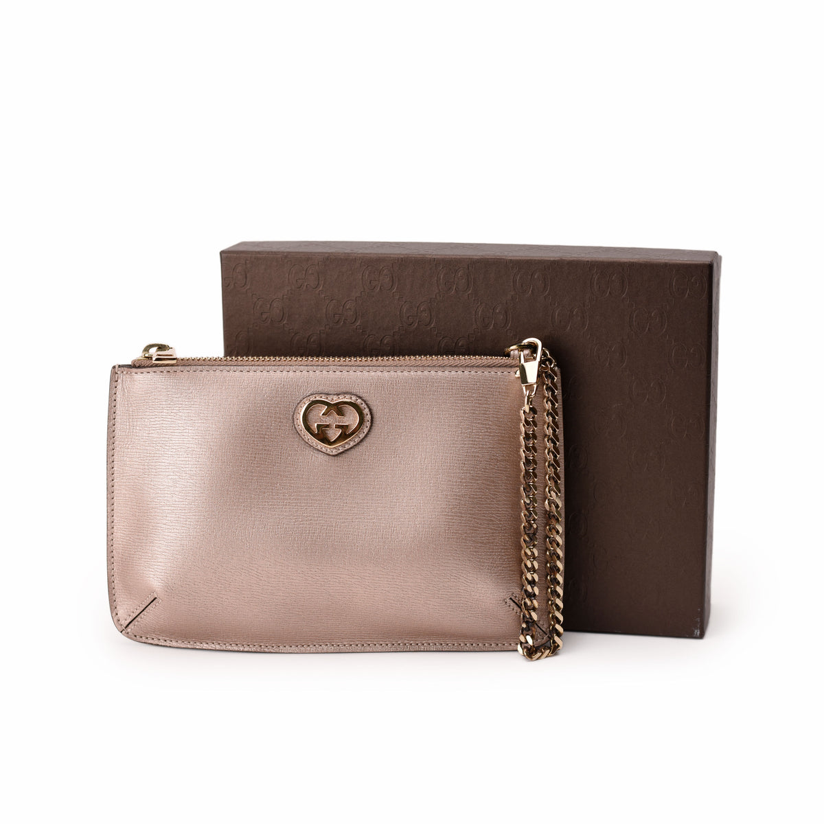 Gucci metallic rose gold leather crossbody bag with heart emblem. curated Pre-loved Luxury by Myluxe in Helsinki.