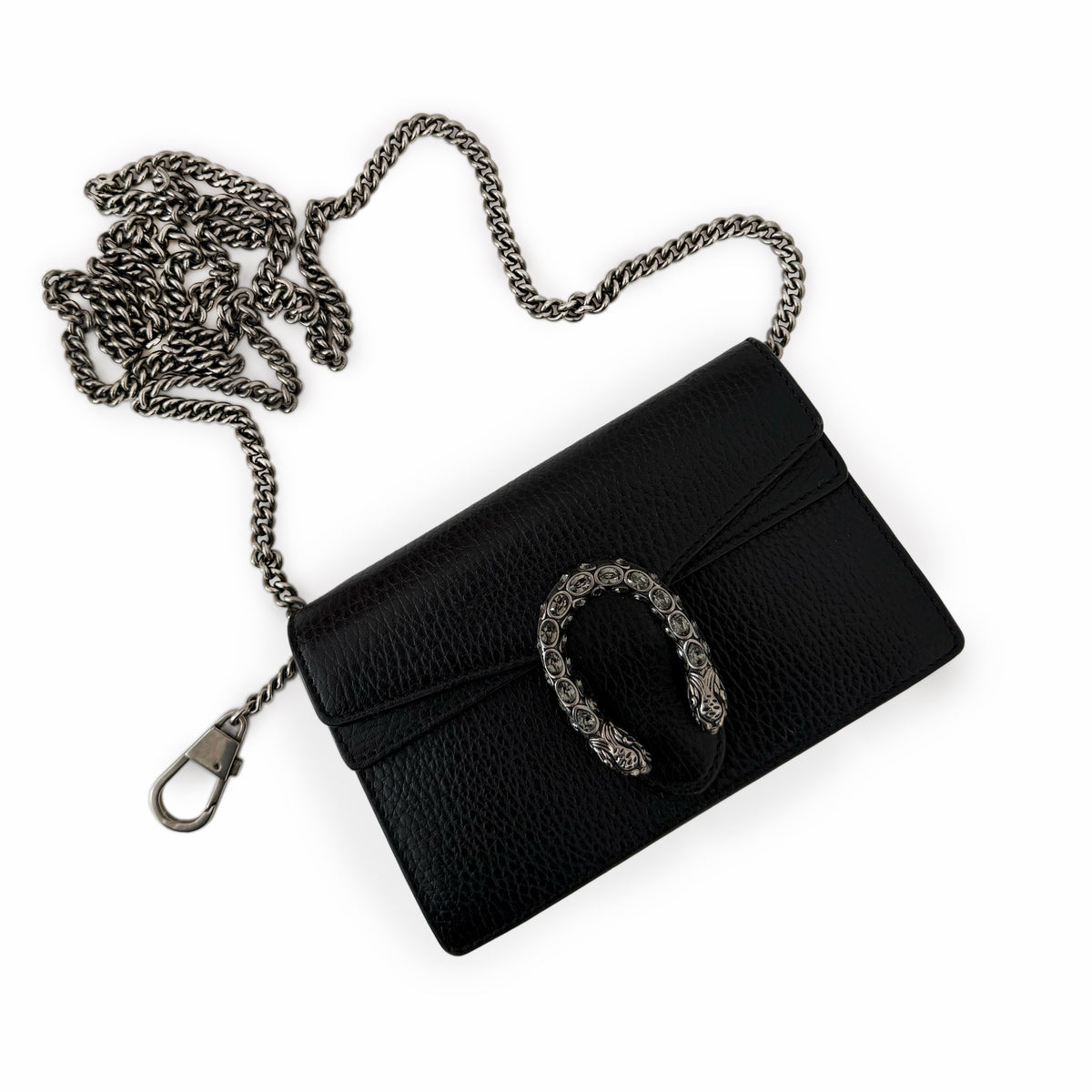 Black pebbled leather crossbody bag with an ornate silver-tone metal buckle, curated Pre-loved Luxury by Myluxe in Helsinki.