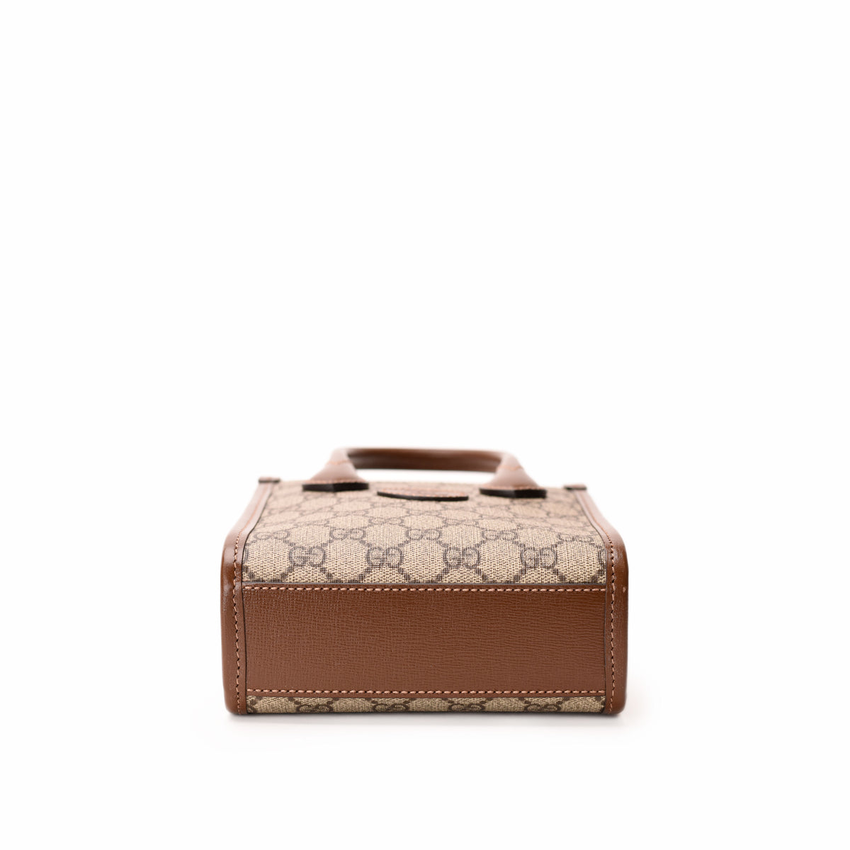 Gucci Interlocking G Mini Tote Bag in GG Supreme Canvas with leather handles and gold-tone hardware.