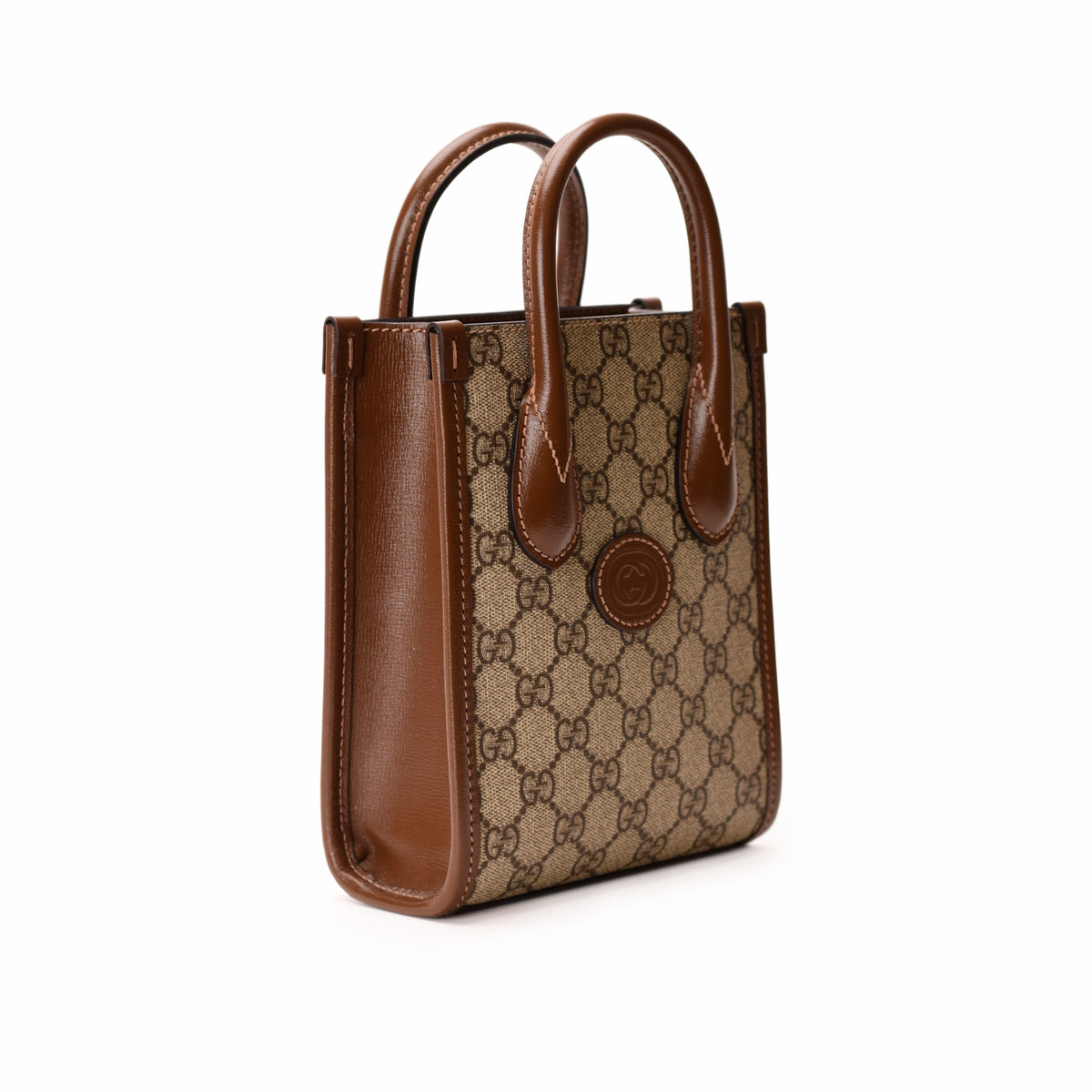 Gucci Interlocking G Mini Tote Bag in GG Supreme Canvas with leather handles and gold-tone hardware.