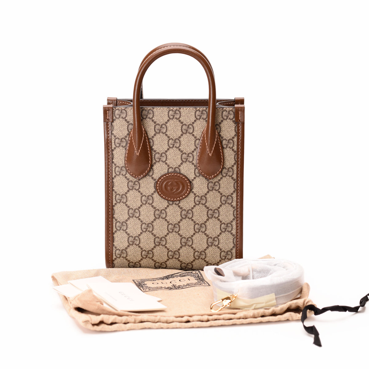 Gucci Interlocking G Mini Tote Bag in GG Supreme Canvas with leather handles and gold-tone hardware.