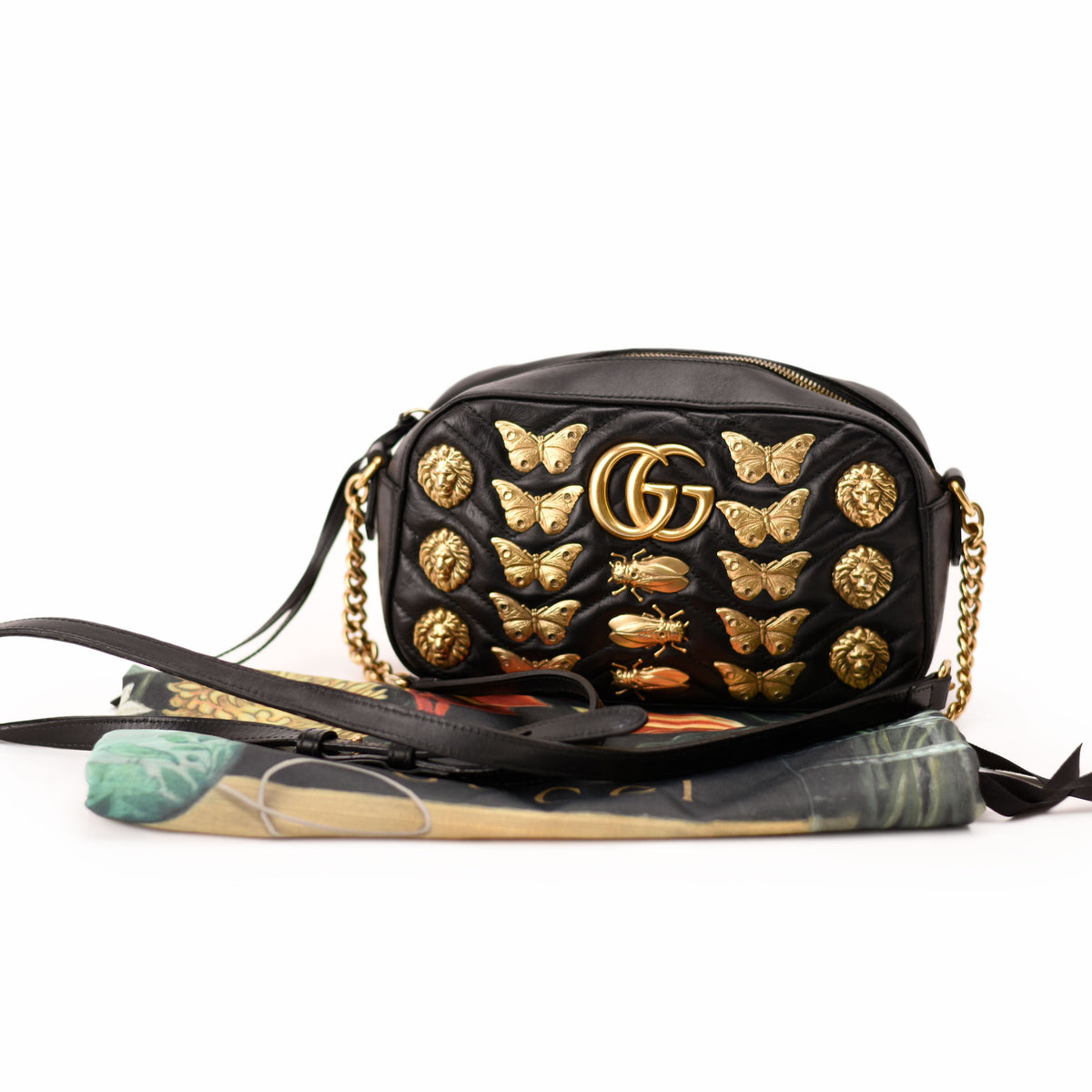Black leather Gucci crossbody bag with gold butterfly and lion embellishments. curated Pre-loved Luxury by Myluxe in Helsinki.