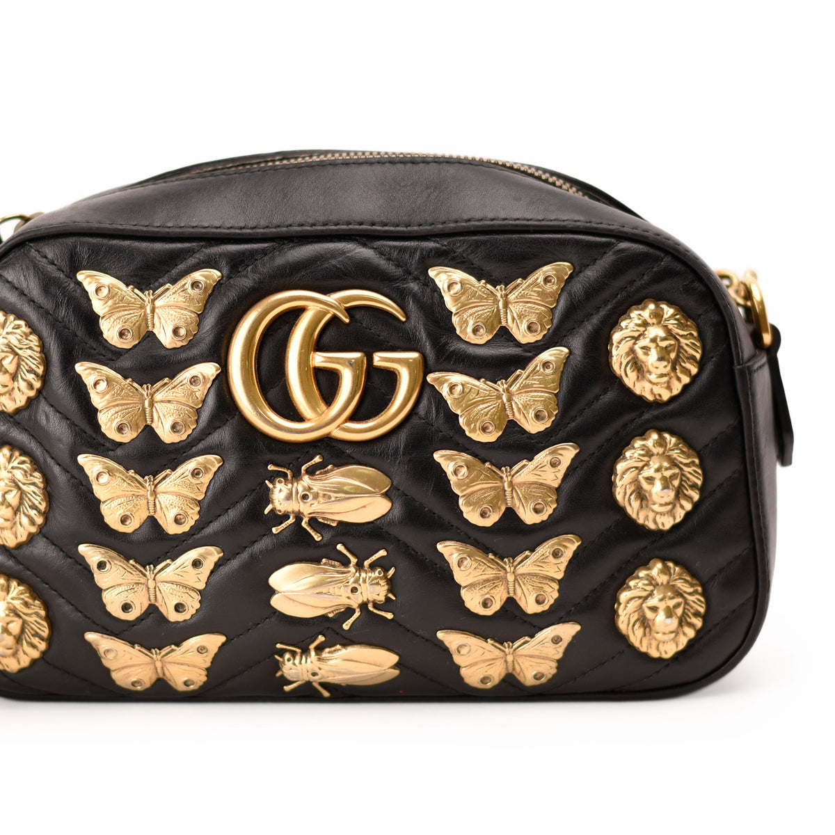 Black quilted leather Gucci bag with gold butterfly and lion embellishments. curated Pre-loved Luxury by Myluxe in Helsinki.