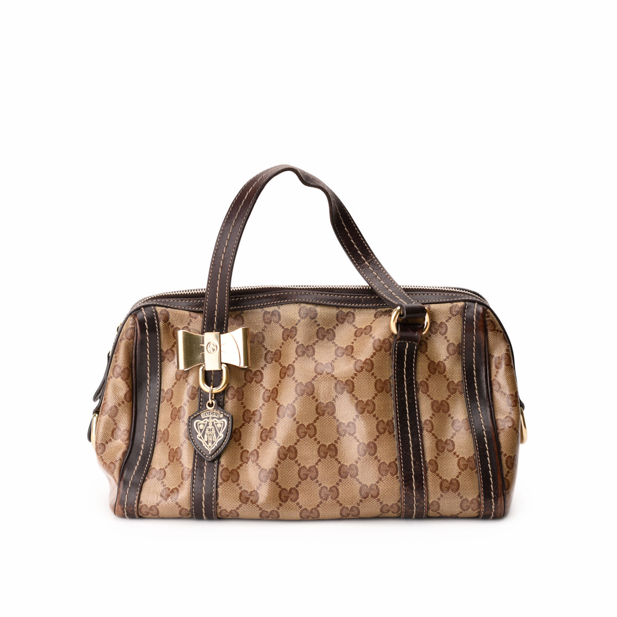 Brown Gucci monogram canvas handbag with gold bow detail, curated Pre-loved Luxury by Myluxe in Helsinki.