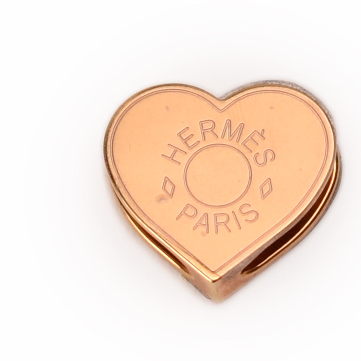 Gold-toned Hermès Paris heart-shaped metal accessory. Curated Pre-loved Luxury by Myluxe in Helsinki.
