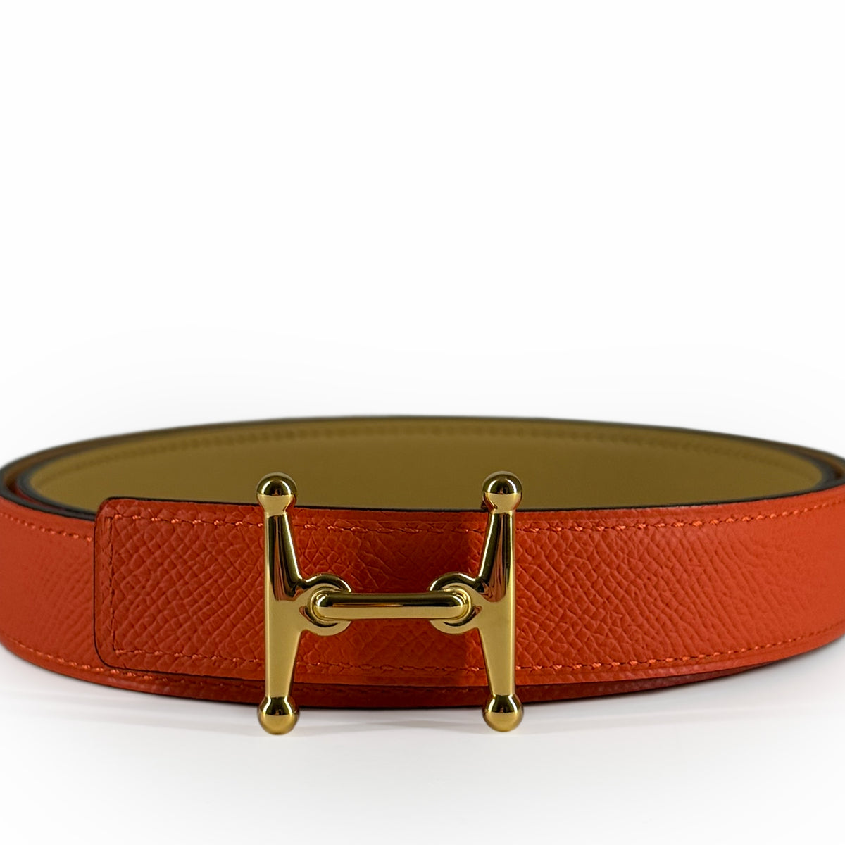 Orange textured leather belt with gold-tone H-shaped buckle, curated Pre-loved Luxury by Myluxe in Helsinki.