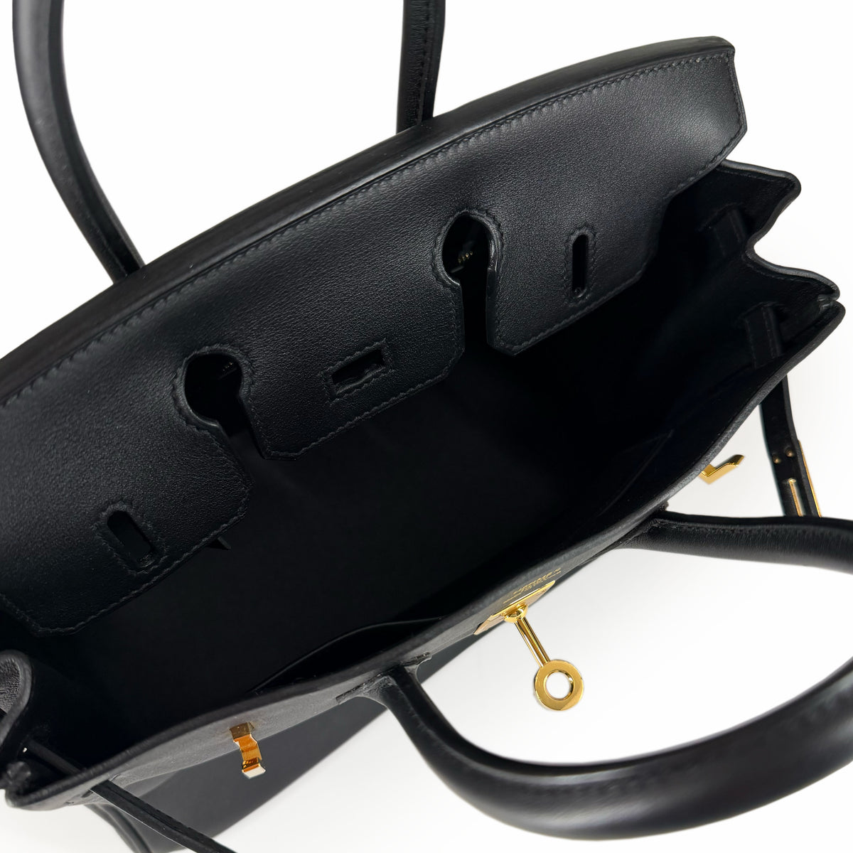 Interior view of a black leather luxury handbag with gold-tone hardware, curated Pre-loved Luxury by Myluxe in Helsinki.