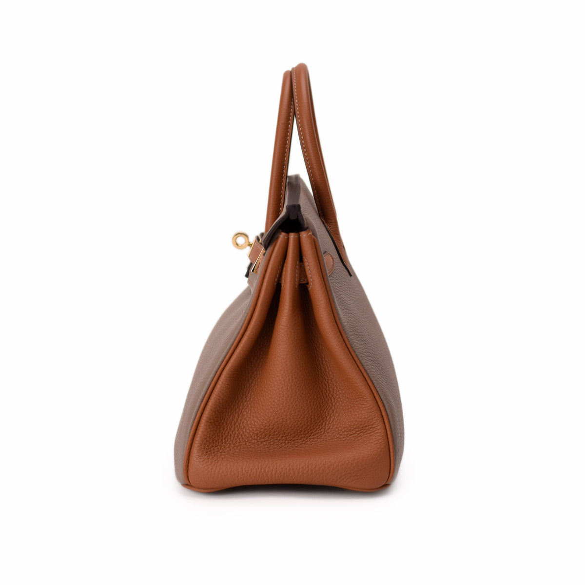 Side view of a brown pebbled leather handbag with dual top handles, curated Pre-loved Luxury by Myluxe in Helsinki.
