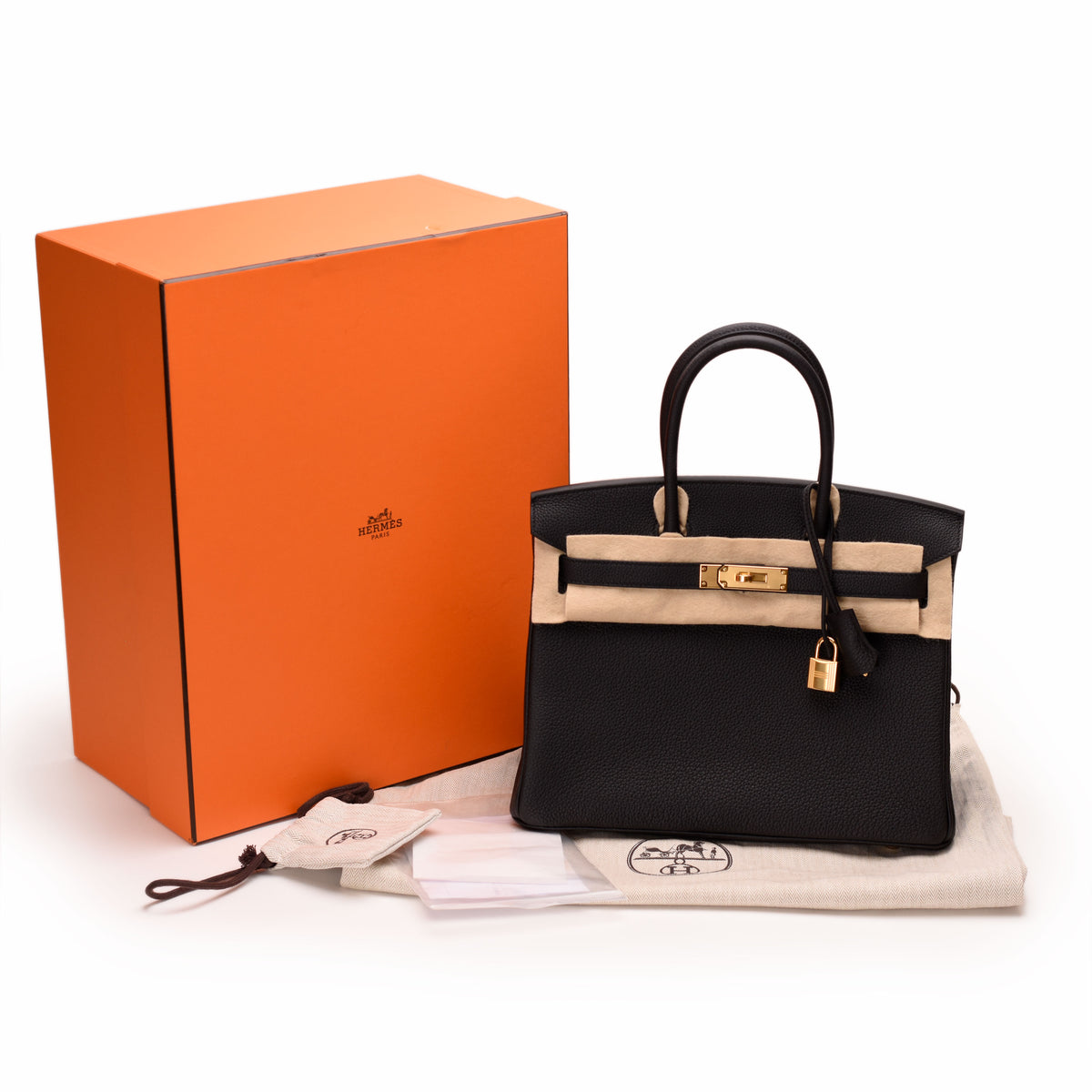 Black leather Hermès Birkin handbag with beige trim and gold hardware. curated Pre-loved Luxury by Myluxe in Helsinki.