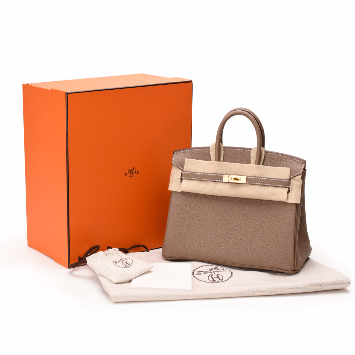 Hermès taupe leather handbag with cream flap and gold hardware. curated Pre-loved Luxury by Myluxe in Helsinki.