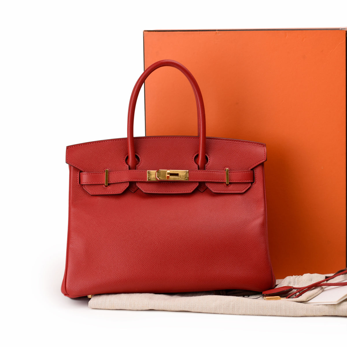 Red Hermès Togo leather handbag with gold hardware. curated Pre-loved Luxury by Myluxe in Helsinki.