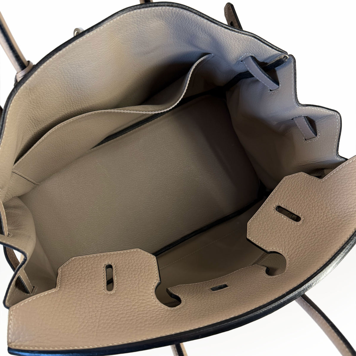 Interior view of a beige grained leather handbag with multiple compartments, curated Pre-loved Luxury by Myluxe in Helsinki.