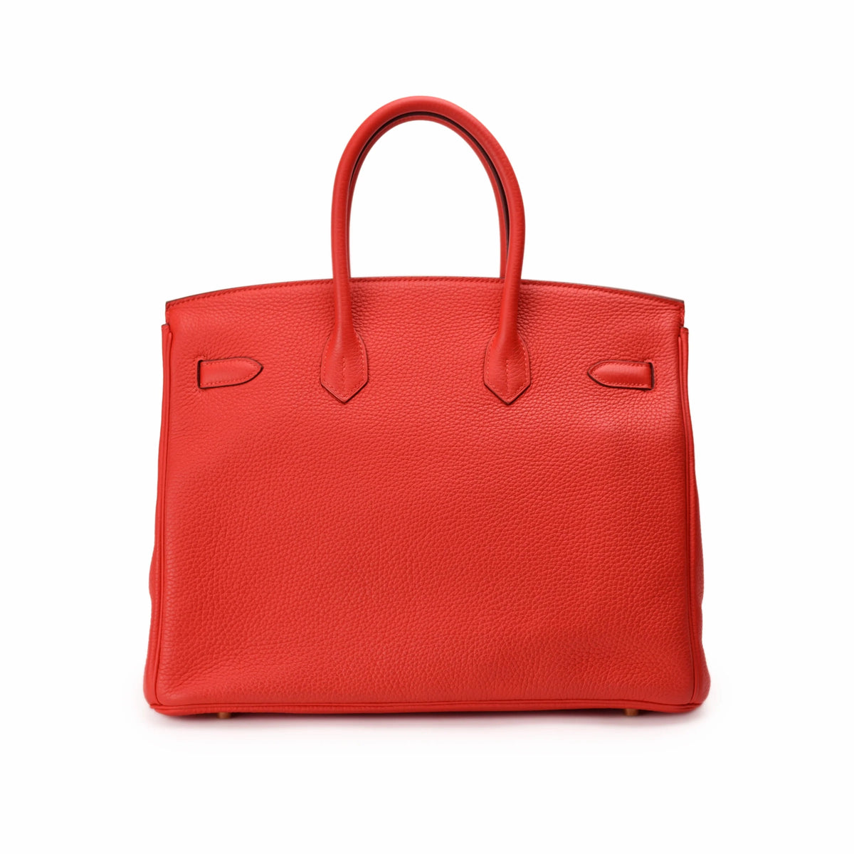 Red textured leather Hermès handbag with dual top handles. curated Pre-loved Luxury by Myluxe in Helsinki.