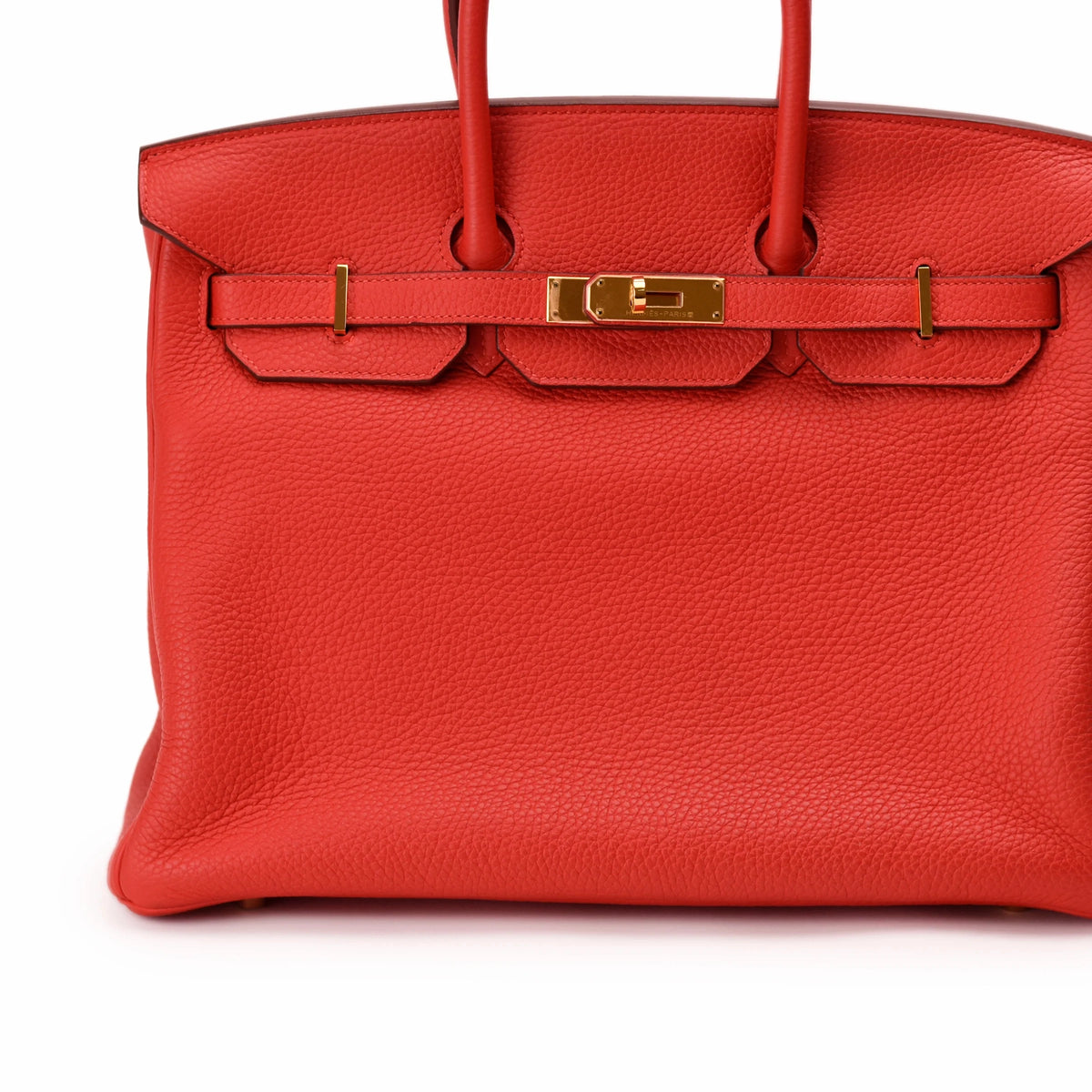 Red Hermès Birkin handbag in textured leather with gold-tone hardware. curated Pre-loved Luxury by Myluxe in Helsinki.