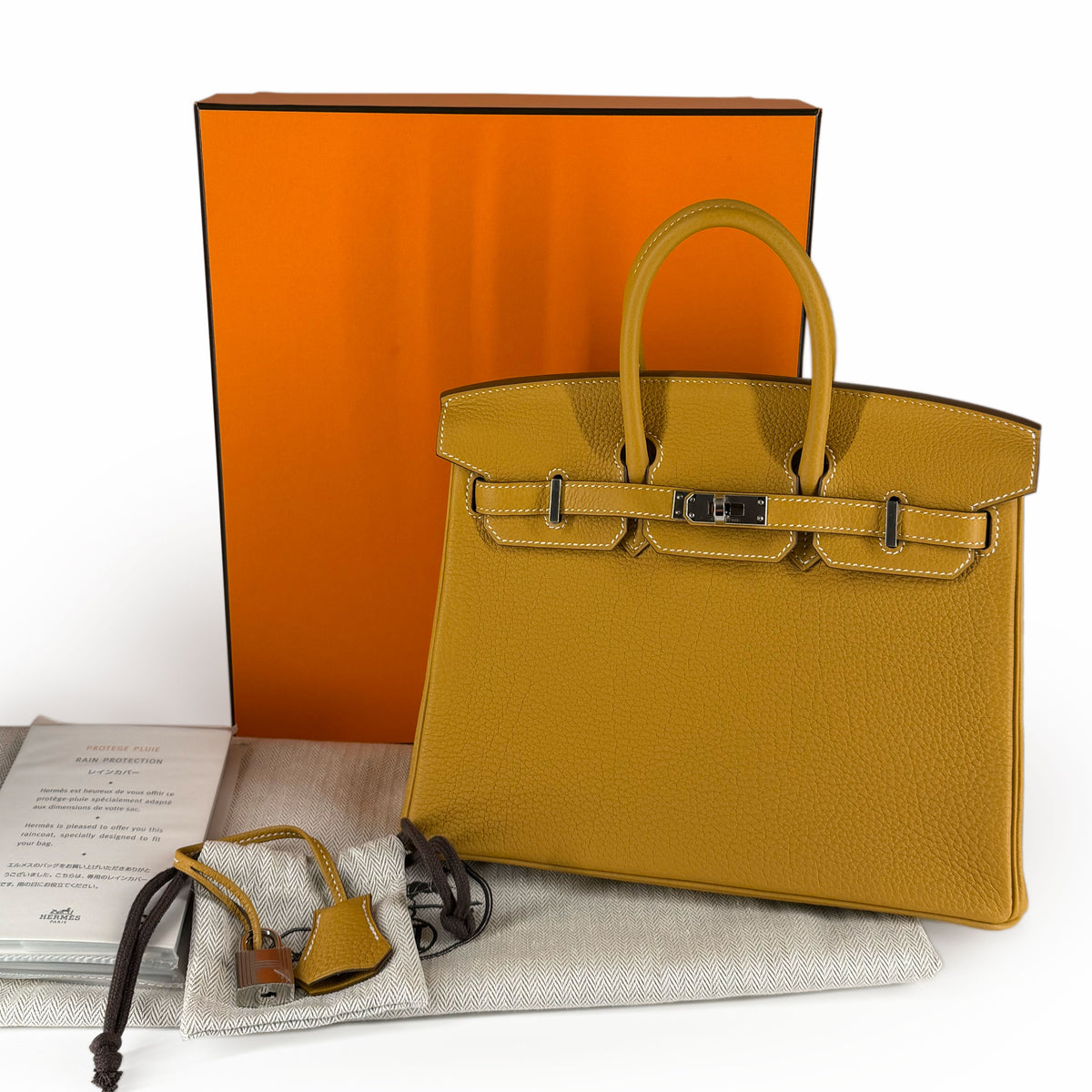 Mustard yellow leather Birkin handbag with silver hardware, curated Pre-loved Luxury by Myluxe in Helsinki.