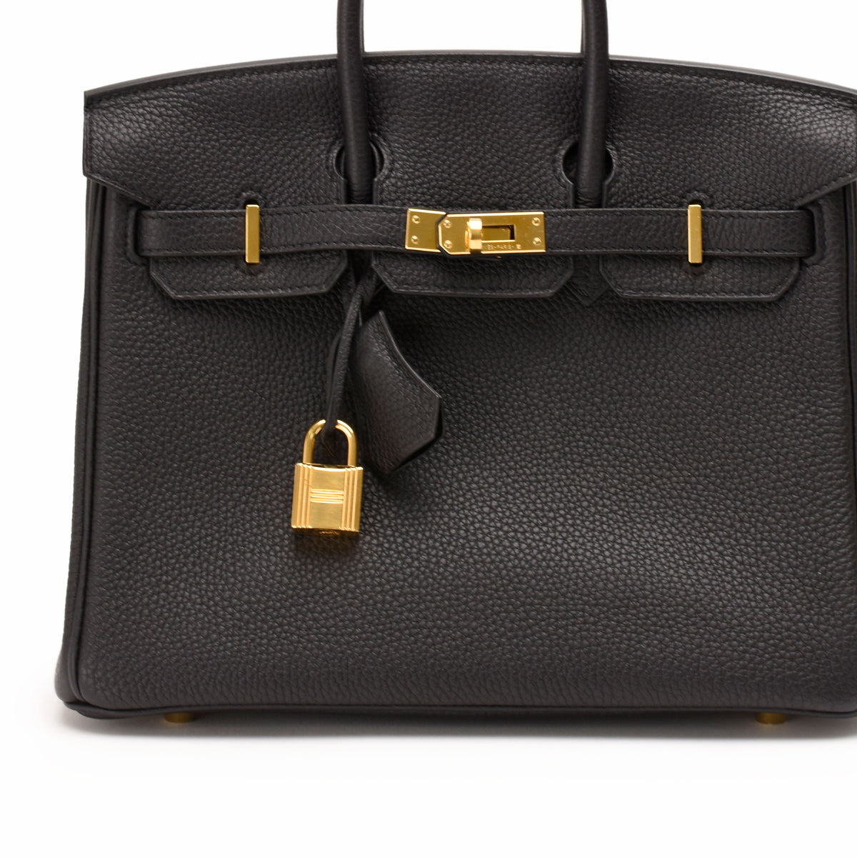 Black Togo leather handbag with gold-tone hardware and padlock, curated Pre-loved Luxury by Myluxe in Helsinki.