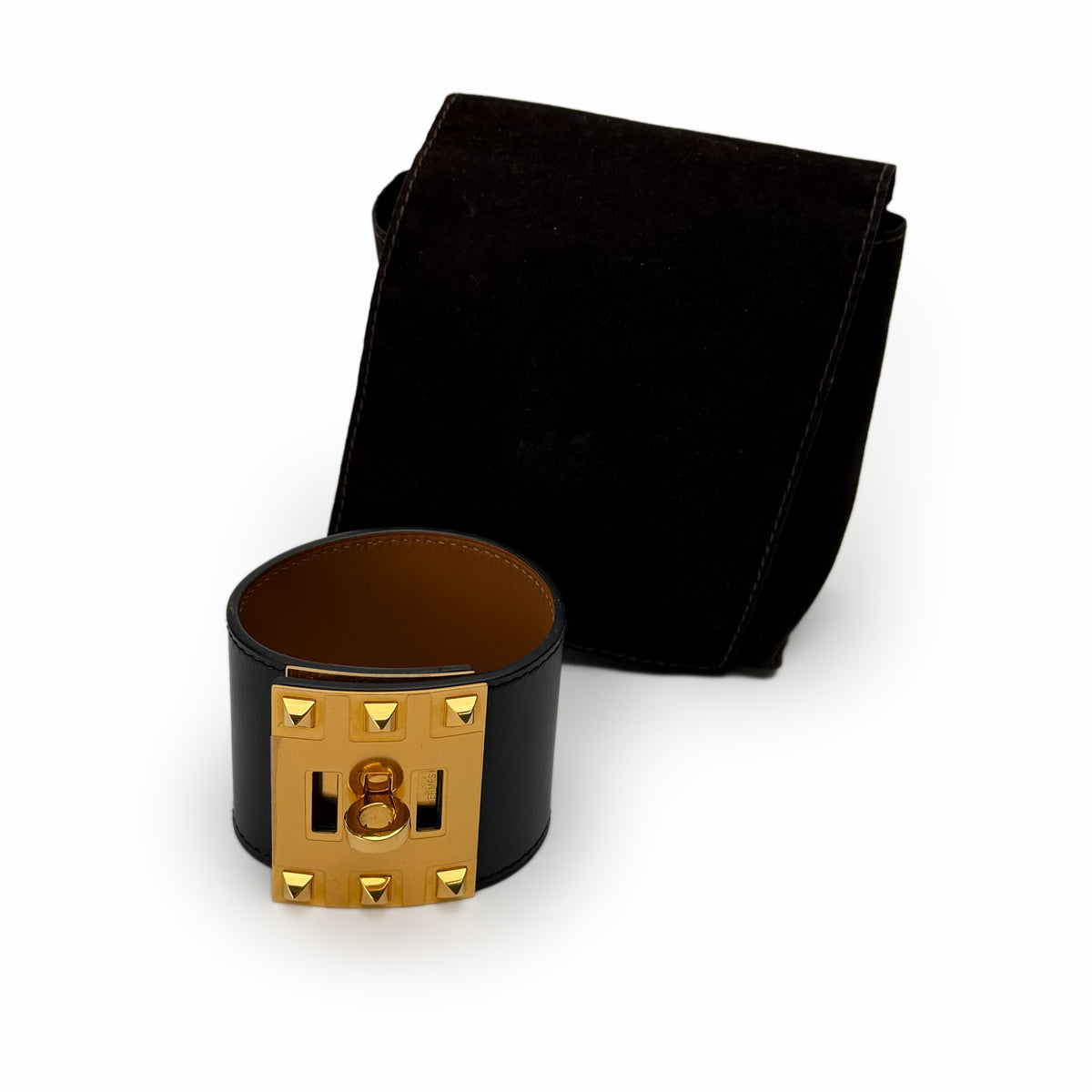 Black leather wide cuff bracelet with gold-tone hardware and matching suede pouch, curated Pre-loved Luxury by Myluxe in Helsinki.