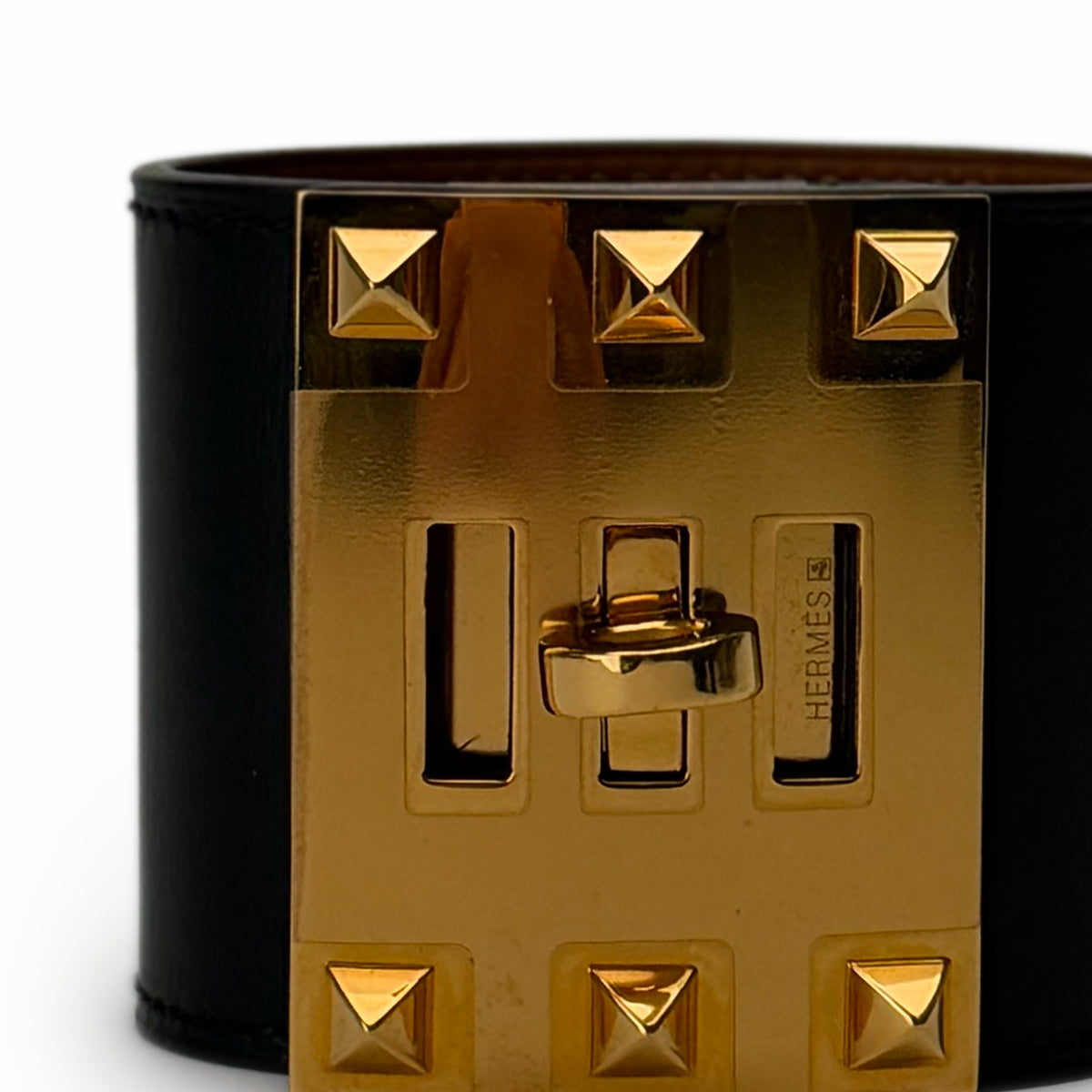 Hermès gold-tone metal studded buckle on a black leather belt, curated Pre-loved Luxury by Myluxe in Helsinki.